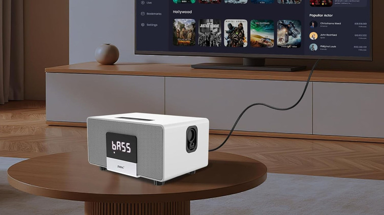 The RHM K222 karaoke machine on a table, connected to a TV