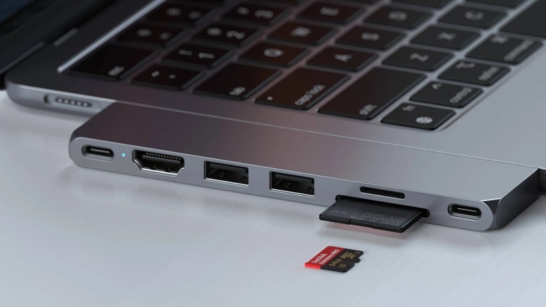 Satechi's Slim Pro Hub dock connected to a MacBook Air with a microSD card in the foreground