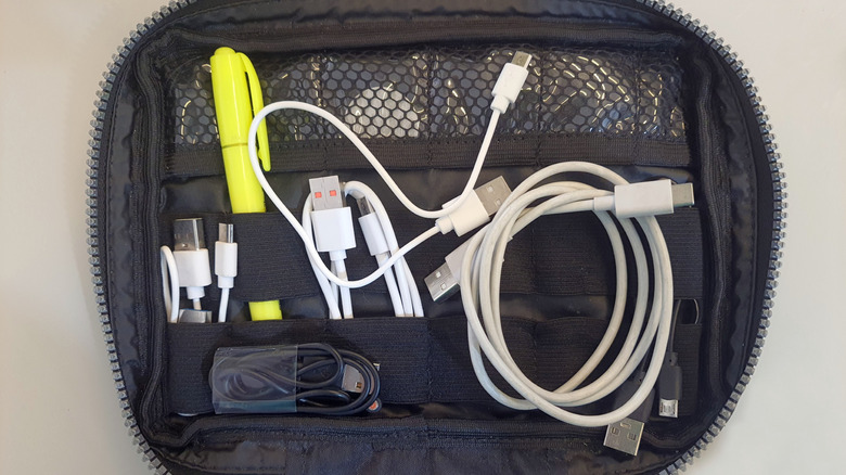 A travel bag containing USB cables is pictured.