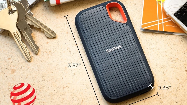 The Sandisk Extreme external SSD is pictured on a wooden surface.