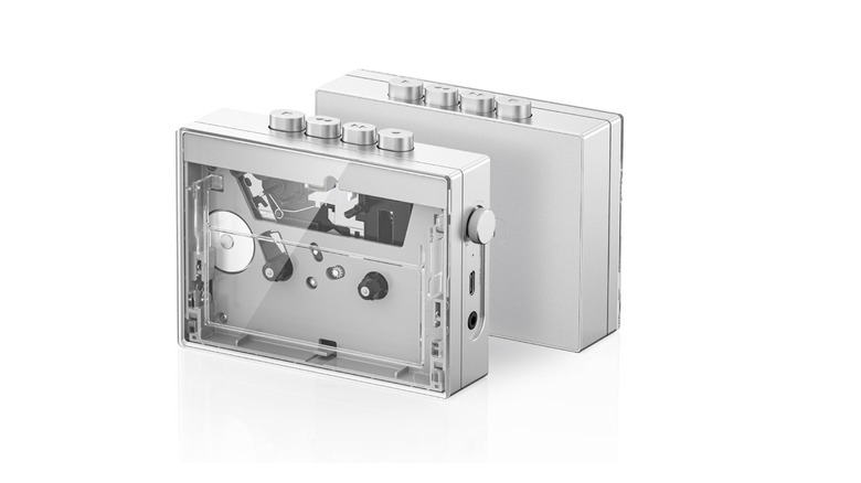 Two silver cassette players facing opposite directions on a plain white background