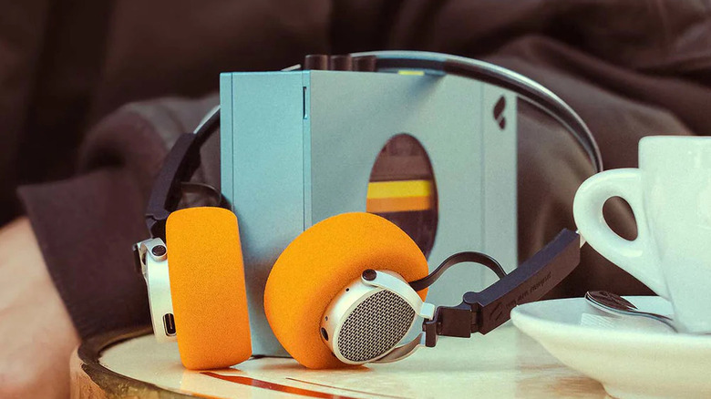 A blue portable cassette deck with headphones around it