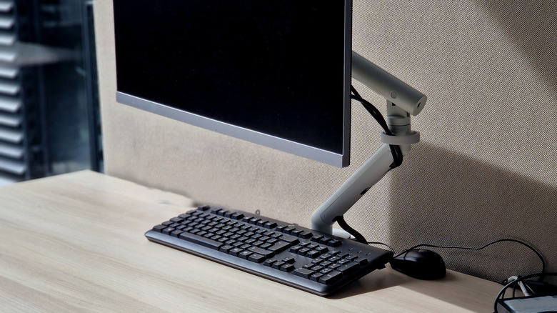 A monitor arm supporting a desktop monitor
