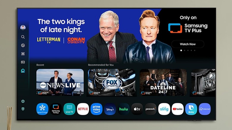 The Samsung S95H wall-mounted in a living room.