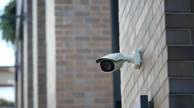 A security camera mounted on a brick wall