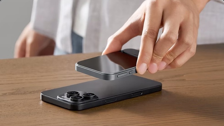 Khadas Tea Pro held in had about to be set on iPhone rear to connect with magnet