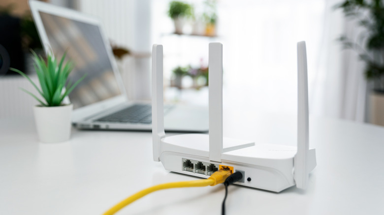 Modern wi-fi router on light table in living room