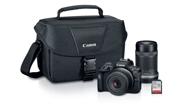A Sam's Club promotional photo for the Canon EOS R100 Two Lens Mirrorless Camera Bundle, the image shows the camera, its two lenses, SD card, and camera bag
