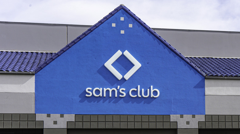 An exterior shot of a Sam's Club building with the Sam's Club logo shown prominently against a blue section of the exterior