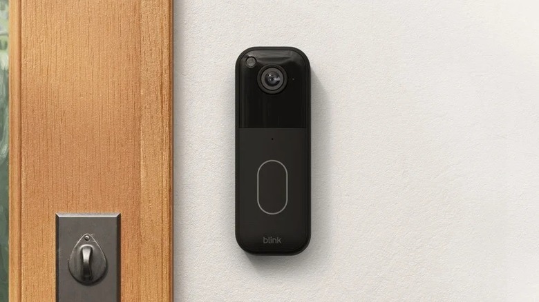 Close-up of the Blink Video Doorbell mounted on the concrete facade of a home