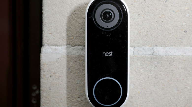 A doorbell with a built-in camera from Nest mouted on the facade of a home