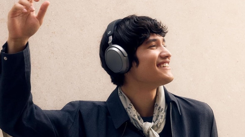 A person wearing the Sennheiser Momentum 4 Wireless Headphones.