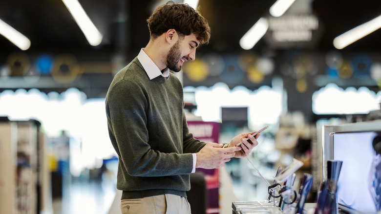 person checking out different smartphones on display