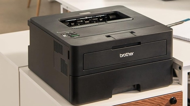 The Brother HL-L2460DW on a wooden desk