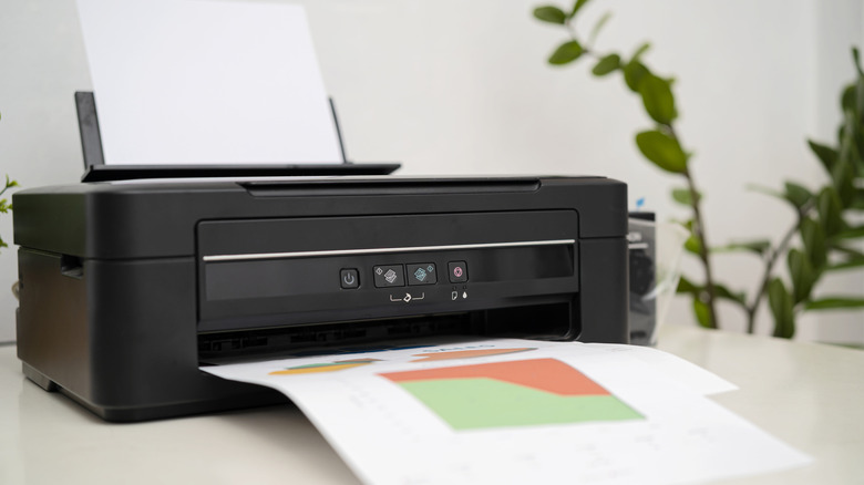 A print on a desk with a blurred plant in the background