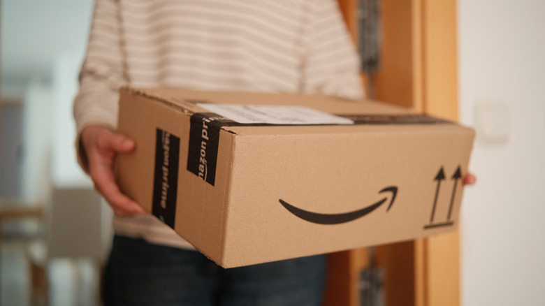 Close up of hands holding an Amazon box