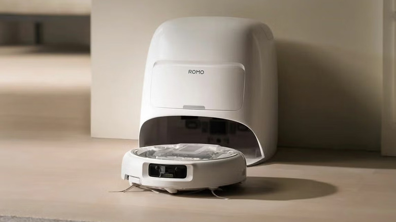 DJI ROMO A robot vacuum returning to its docking station.