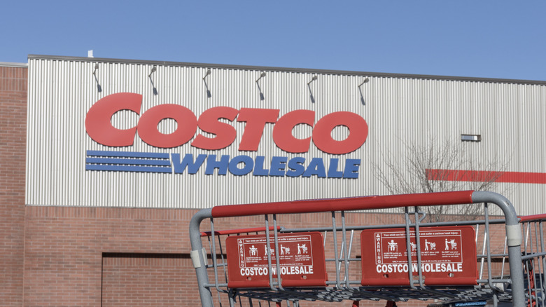 Costco Wholesale storefront with shopping carts outside.