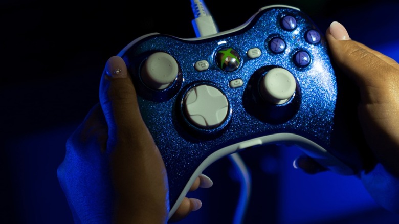 Person holding a blue Hyperkin Xenon controller