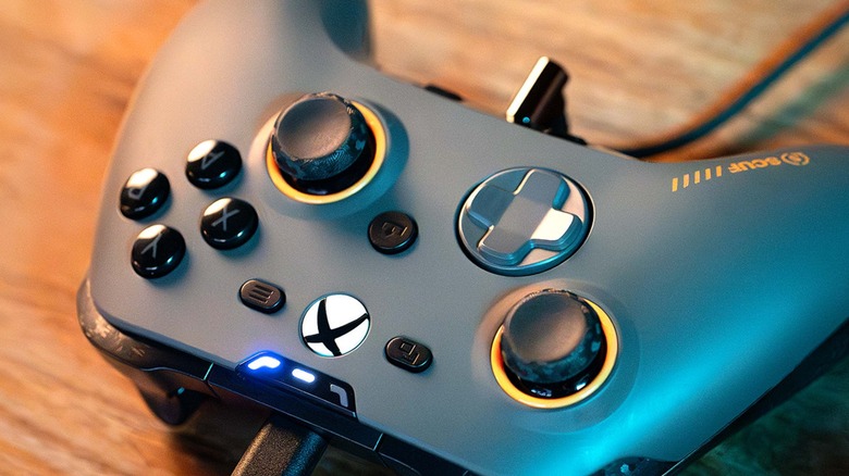 Scuf Valor Pro controller plugged into USB-C cable on wooden table