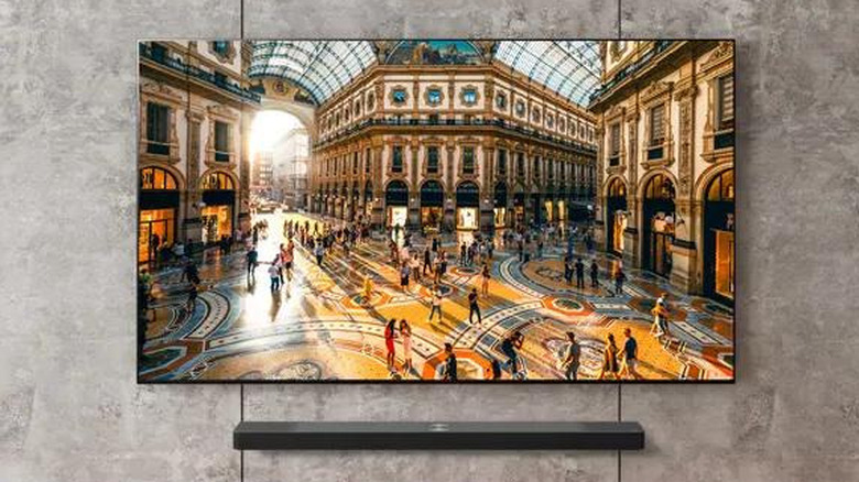 LG G5 OLED TV mounted on wall with soundbar below.