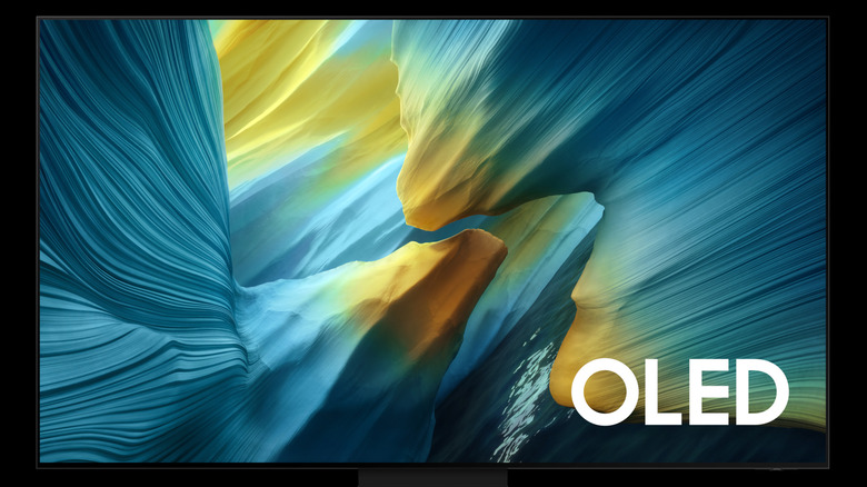 Samsung S95F OLED TV displaying colorful abstract image on screen.