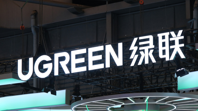 Close-up of the UGREEN company logo on a trade fair stall