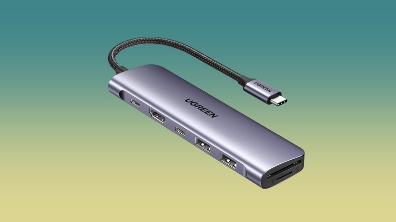 The UGREEN 1071 Revodok 7-in-1 Dock against a gradient background