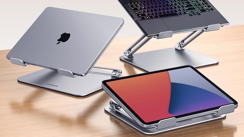 Three UGREEN Portable Laptop Stand units on a wooden tablet