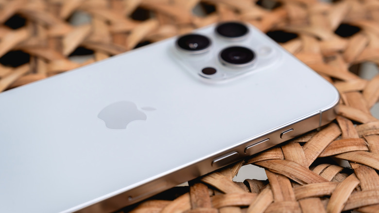 iPhone laying face down showing Action button and volume control