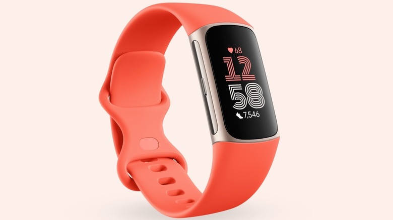 A Fitbit Charge 6 smartwatch with an orange band