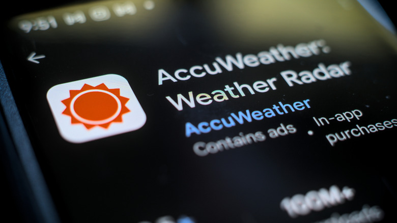 Photo of AccuWeather mobile app store listing on screen of phone
