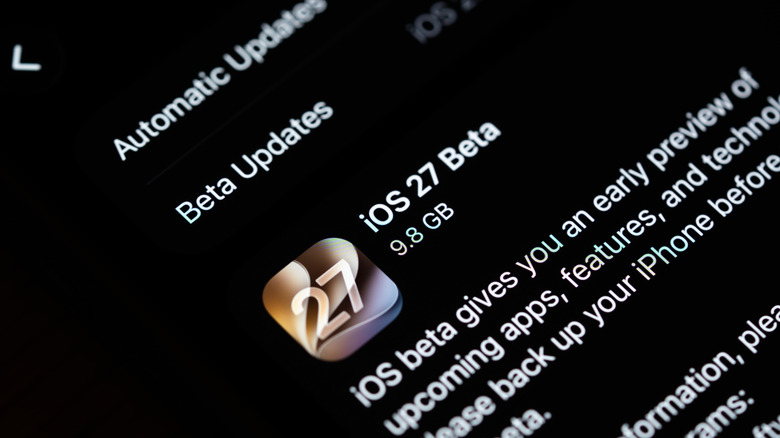 A close-up of an iPhone about to be updated to an iOS 27 beta release.