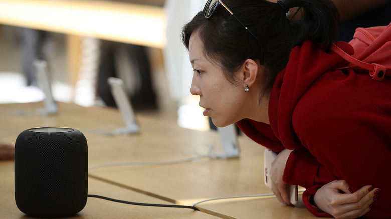 A customer tests the new Apple HomePod at an Apple Stor