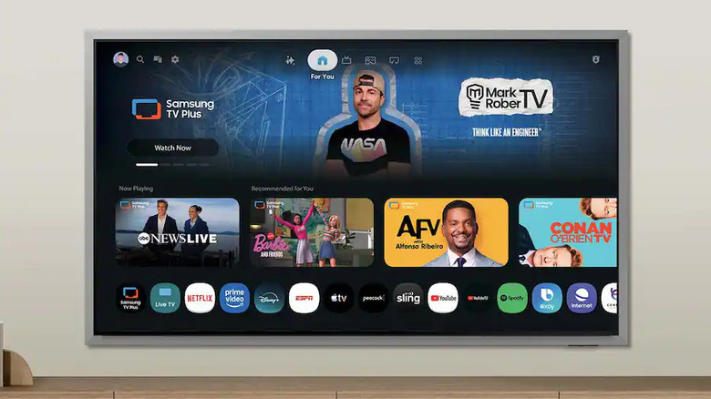 The Samsung S95 wall-mounted above a TV stand.