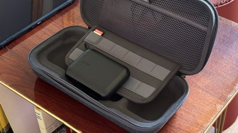 Belkin's Charging Case for Nintendo Switch 2 on a desk with a power bank and a Switch 1 cartridge.