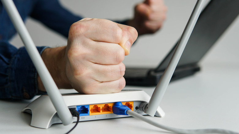 Fist being slammed onto WiFi router