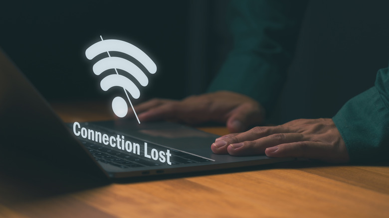 A laptop with a connection lost illustration above it