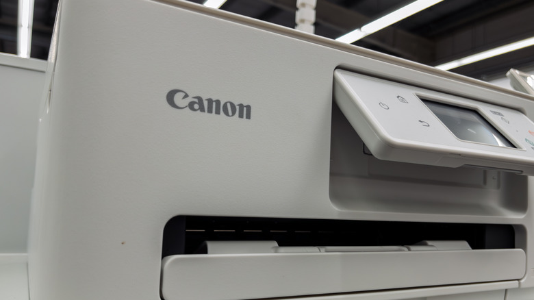 A Canon printer on display in an electronics store.