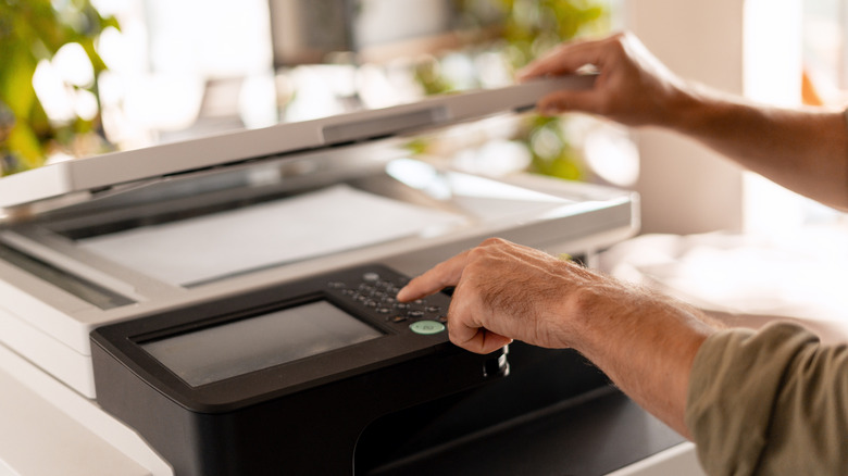 A person using a multifunction printer.