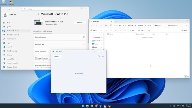 Printer print queue and the spool folder open on the desktop of a Windows 11 PC