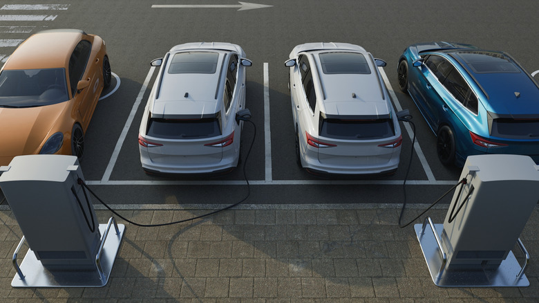 Multiple EVs charging at public electric vehicle charging station parking lot