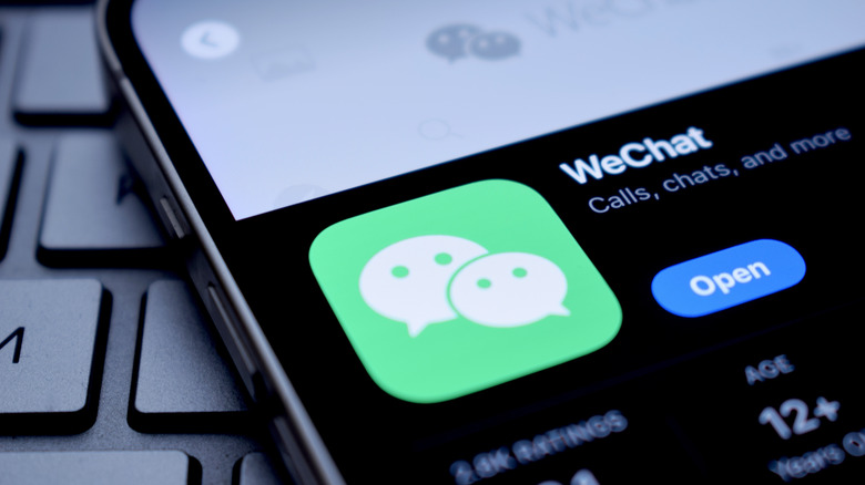 On the screen, the logo of the WeChat application is visible.