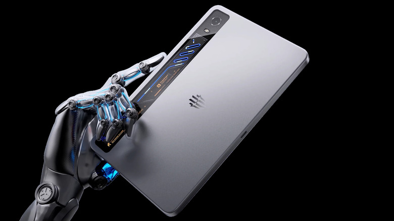 RedMagic Astra 2 gaming tablet shown from the back with a robotic hand holding it.