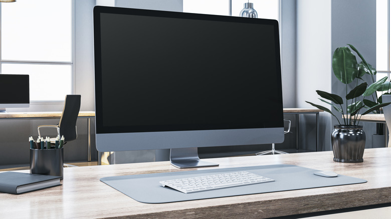a desktop setup with monitor keyboard and mouse