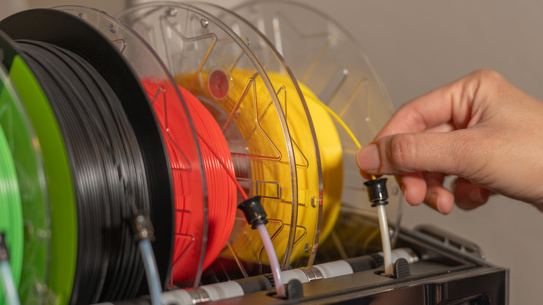 3D printer filament being fed into a 3D printer