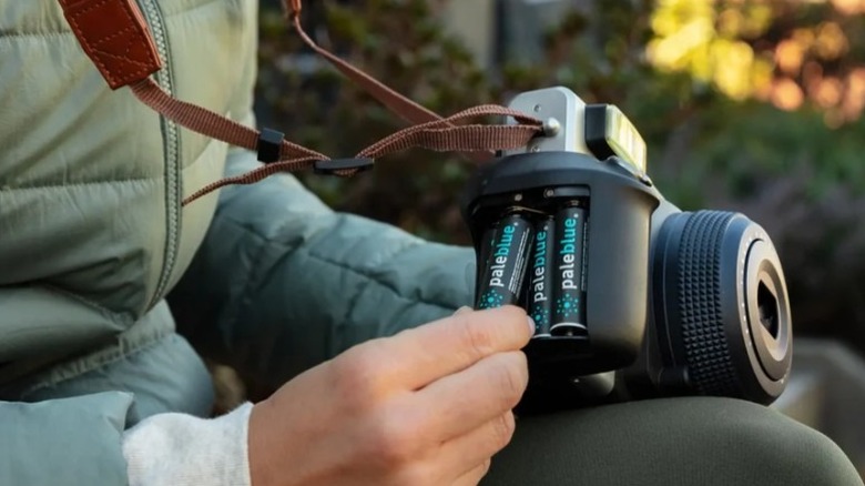 Loading Paleblue USB rechargeable batteries into a camera