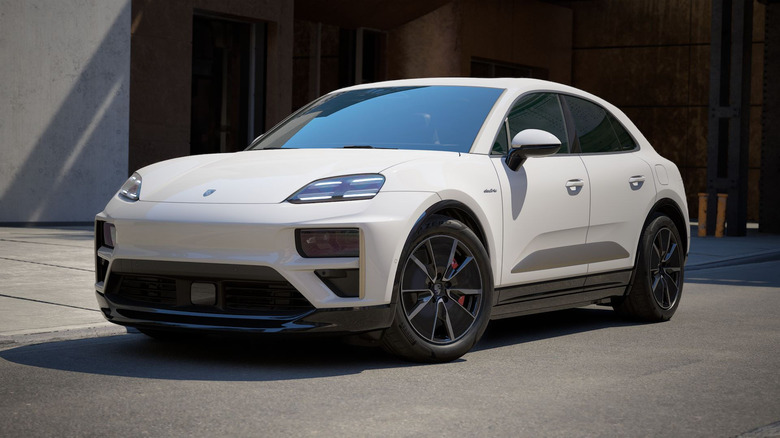 A white Porsche Macan Turbo Electric on display outdoors