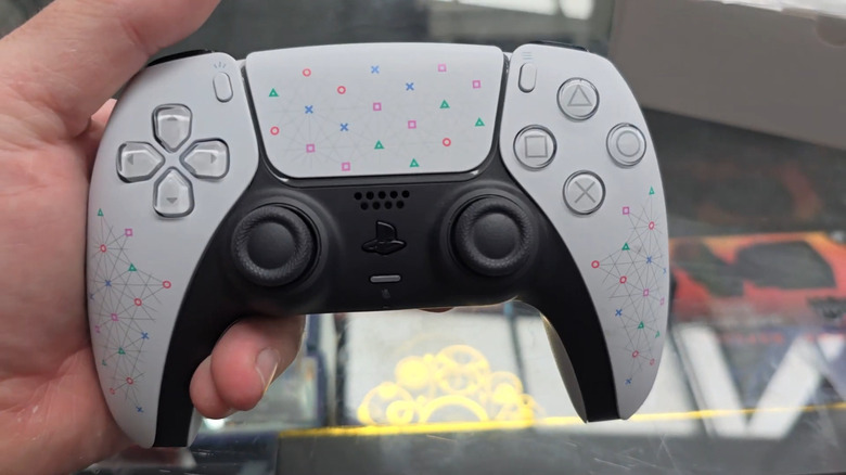 person holding the DualSense Play Has No Limits edition controller with patterned design