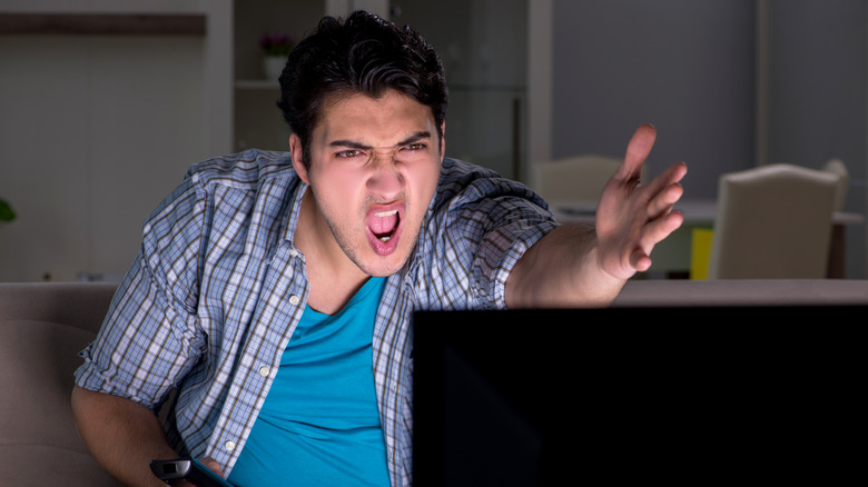 person yelling at their tv